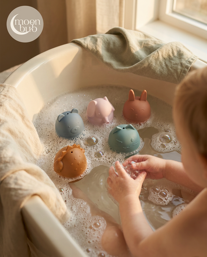 Child playing with colorful bath toys in a bathtub filled with water.